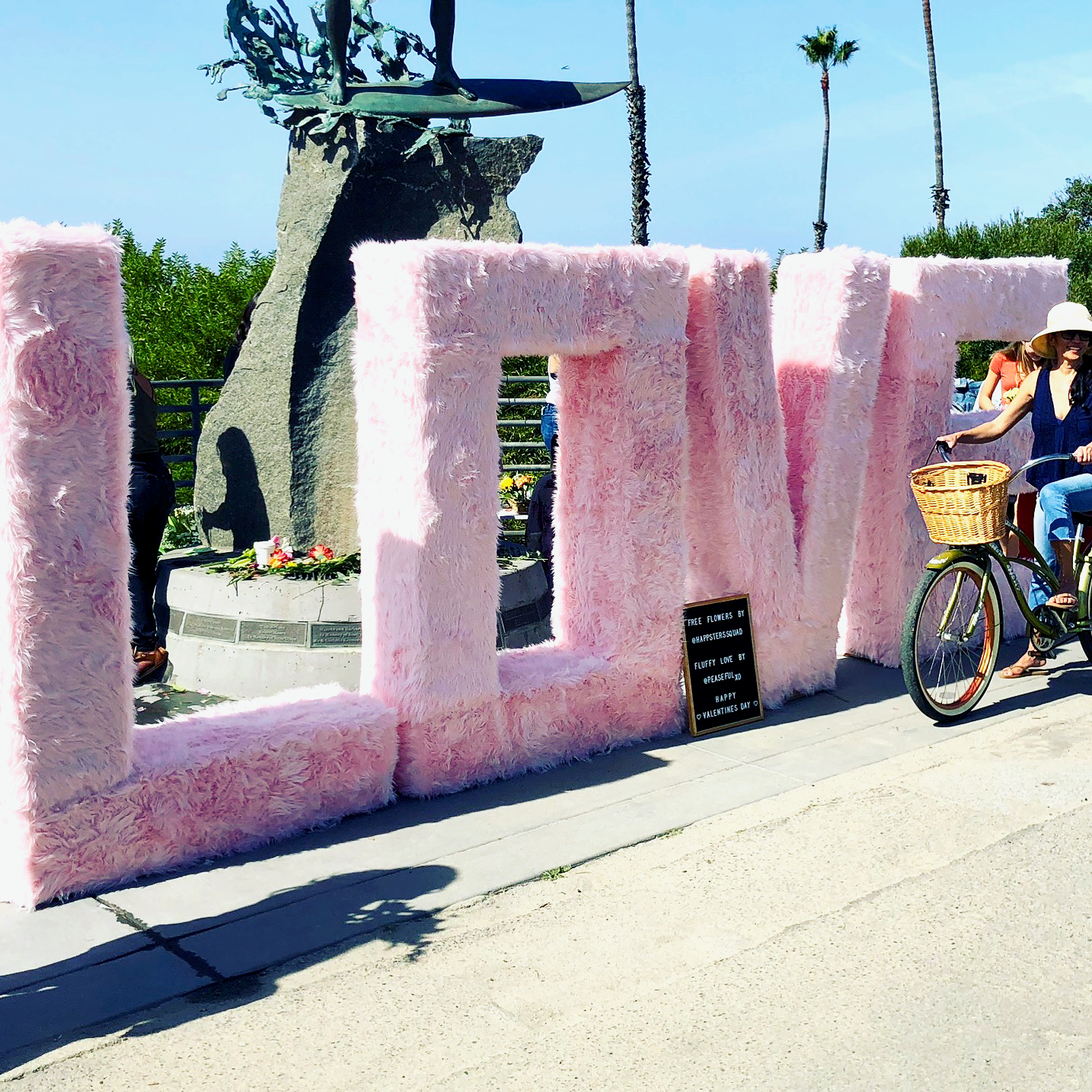 Load video: San Diego immersive art lovers enjoying the Burnt Module art installation called FLUFFY LOVE -- a giant fluffy pink love sign